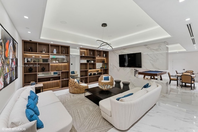 living room featuring billiards and a tray ceiling