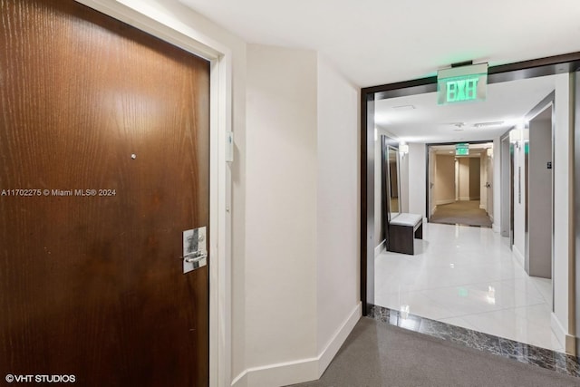 corridor with tile patterned flooring