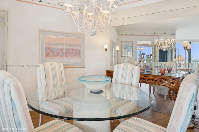 dining area with a notable chandelier and hardwood / wood-style flooring