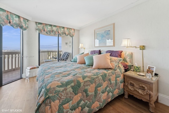 bedroom featuring access to outside, ornamental molding, and hardwood / wood-style flooring