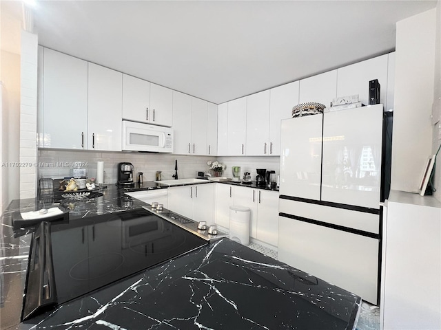 kitchen with white cabinets, decorative backsplash, white appliances, and sink