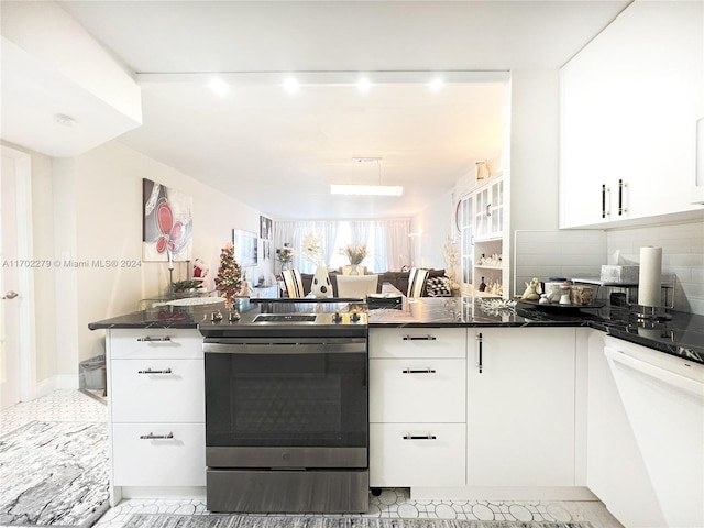 kitchen with white cabinets, backsplash, white dishwasher, and stainless steel electric range