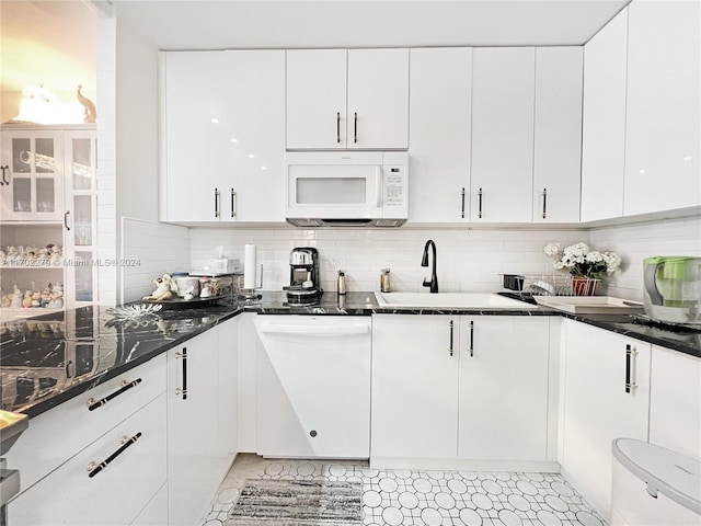 kitchen featuring white cabinets, white appliances, sink, and tasteful backsplash