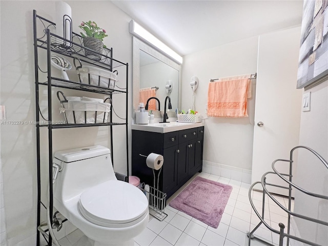 bathroom with tile patterned flooring, vanity, and toilet