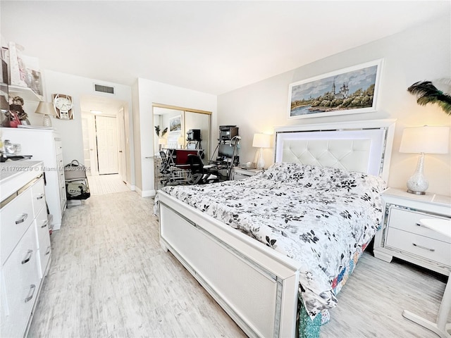 bedroom featuring light hardwood / wood-style flooring and a closet