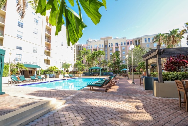 view of swimming pool with a pergola and a patio