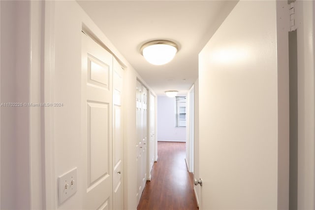 corridor with dark hardwood / wood-style floors