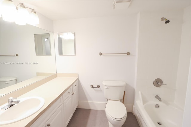 full bathroom with vanity, tiled shower / bath combo, and toilet