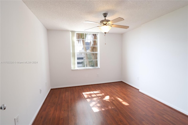 empty room with a textured ceiling, ceiling fan, and dark wood-type flooring