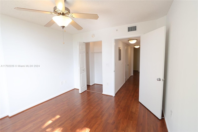 unfurnished room featuring a textured ceiling, ceiling fan, and dark hardwood / wood-style floors