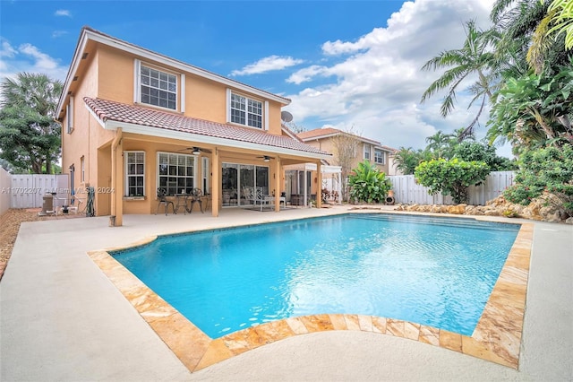 view of swimming pool featuring ceiling fan and a patio area