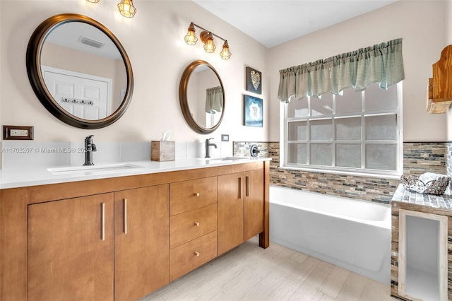 bathroom with decorative backsplash, a bathtub, and wood-type flooring