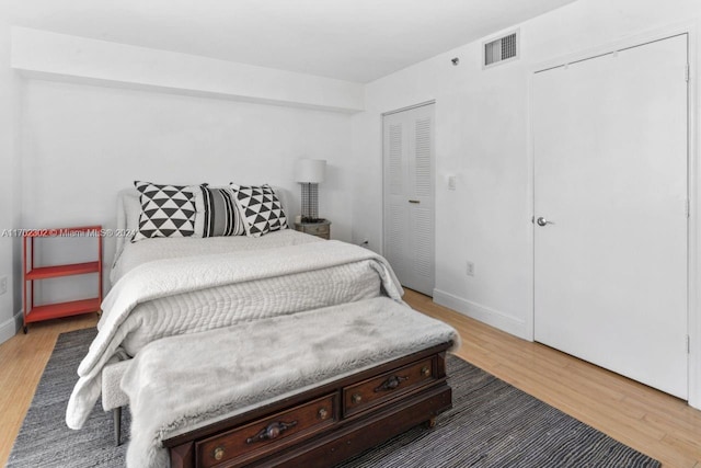 bedroom featuring hardwood / wood-style floors and a closet