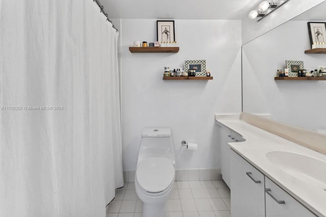 bathroom featuring tile patterned flooring, vanity, and toilet