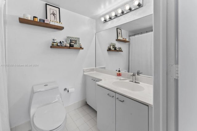 bathroom with tile patterned flooring, vanity, and toilet