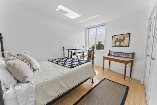 bedroom with a closet and light hardwood / wood-style flooring