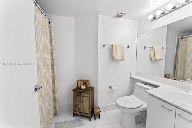 bathroom with tile patterned floors, vanity, and toilet