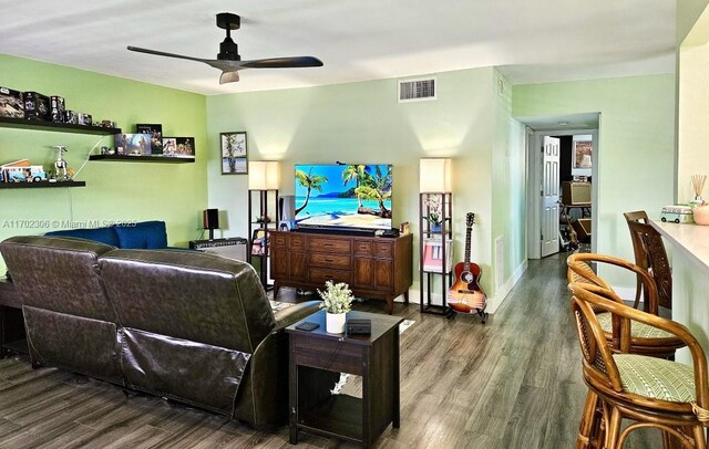 living room with wood-type flooring and ceiling fan