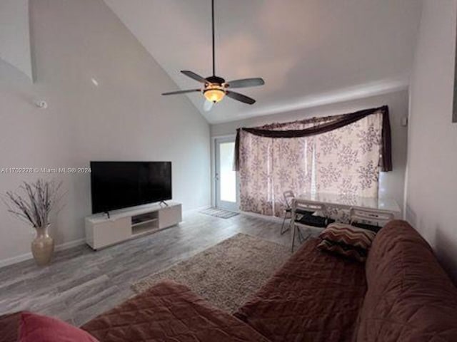 living room featuring hardwood / wood-style floors, ceiling fan, and high vaulted ceiling