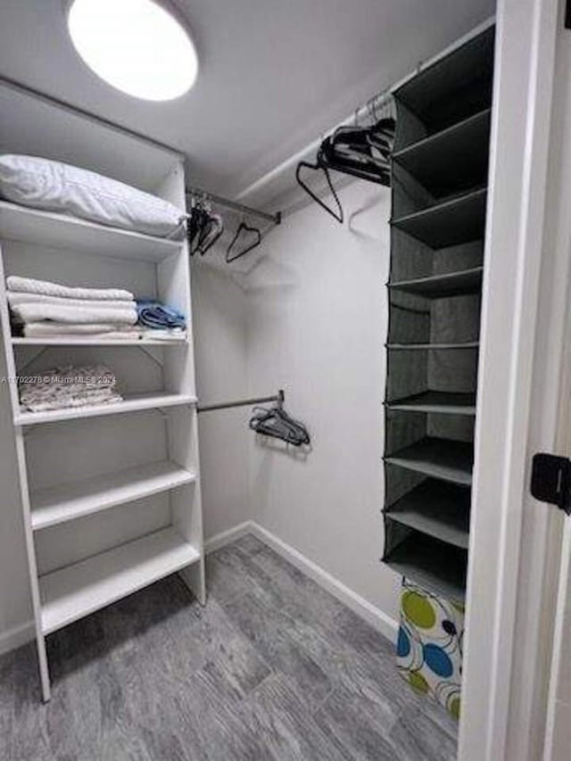 walk in closet featuring hardwood / wood-style flooring