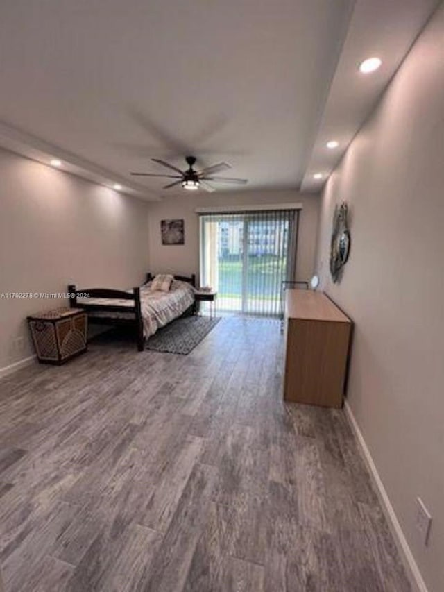 unfurnished bedroom featuring access to outside, ceiling fan, and hardwood / wood-style floors