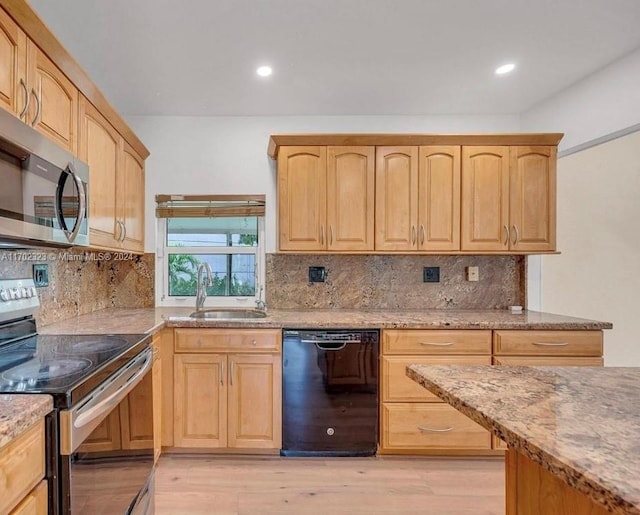 kitchen with sink, light brown cabinets, stainless steel appliances, light stone counters, and light wood-type flooring