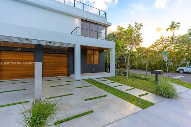 exterior space featuring a balcony and a garage