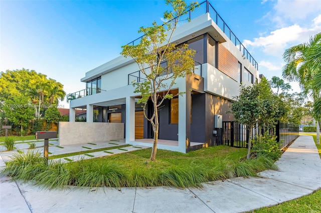 exterior space with a front yard and a balcony