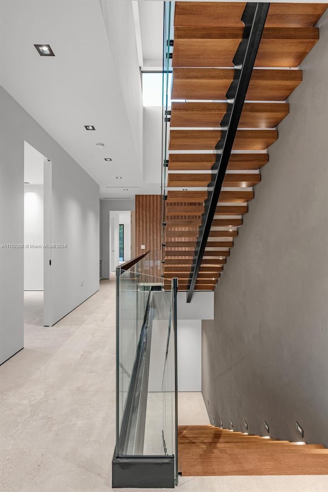 stairs featuring concrete flooring