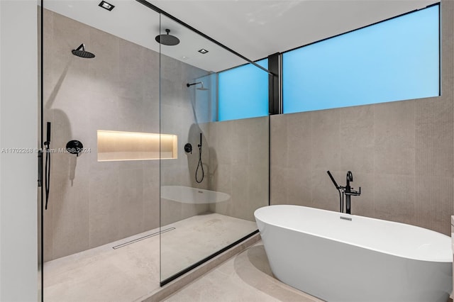 bathroom featuring separate shower and tub