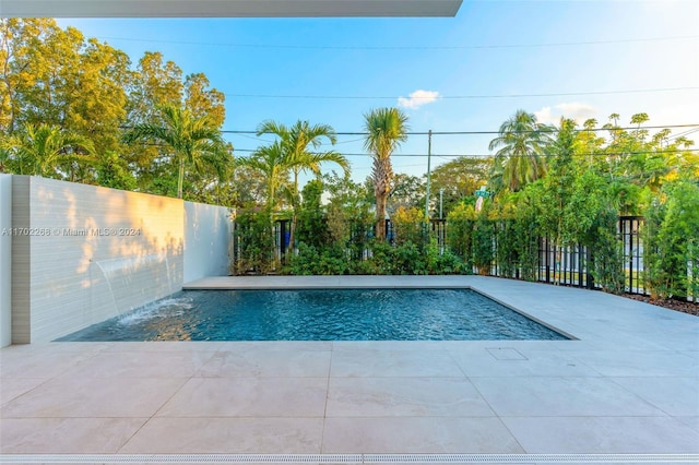 view of swimming pool with pool water feature