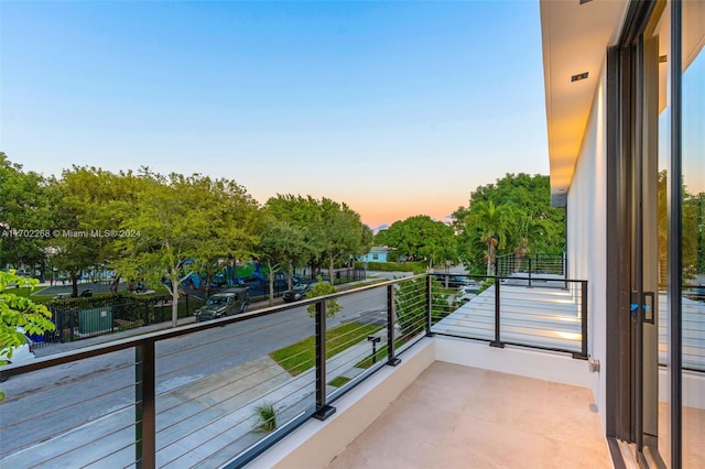 view of balcony at dusk