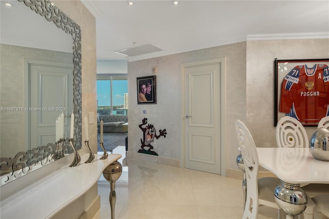 interior space with tile patterned floors and ornamental molding