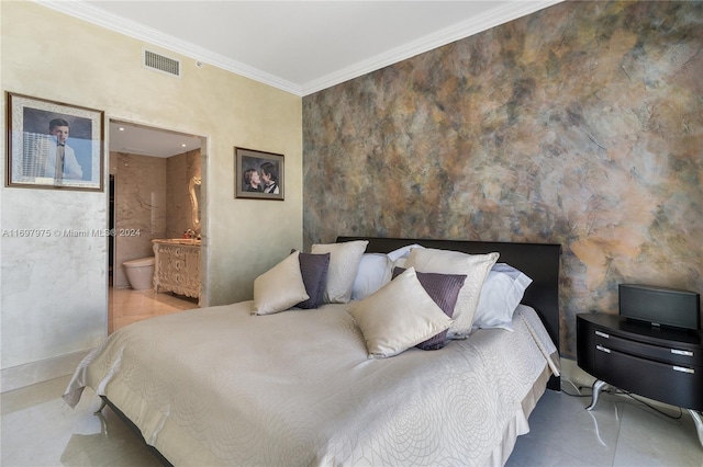 bedroom featuring ornamental molding and ensuite bath