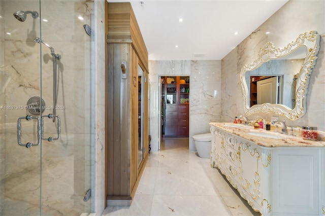 bathroom featuring vanity, toilet, and a shower with shower door