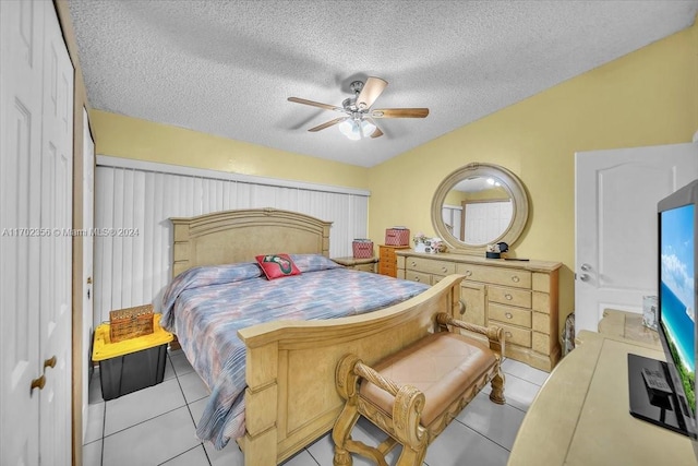 bedroom featuring light tile patterned floors, a textured ceiling, and ceiling fan