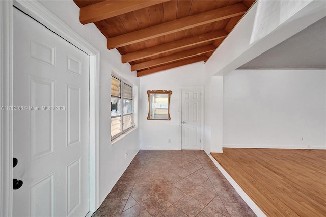 interior space with vaulted ceiling with beams, tile patterned flooring, and wooden ceiling