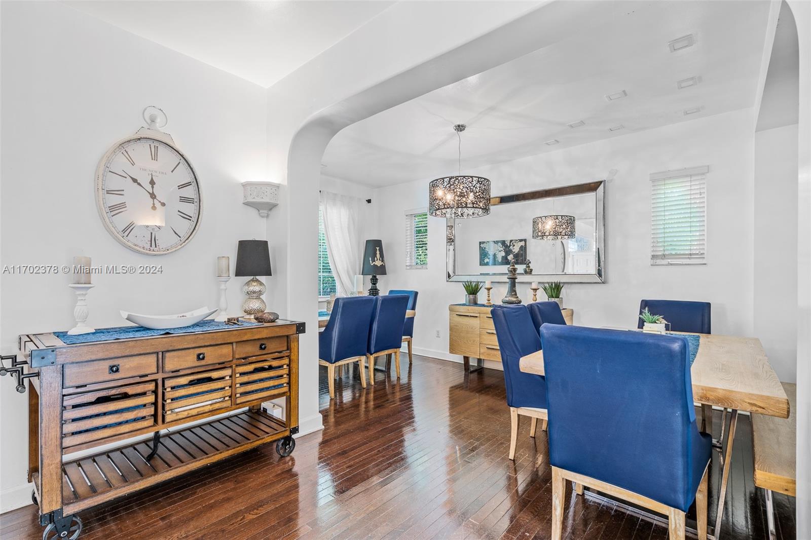 dining space featuring a chandelier, a wealth of natural light, and dark wood-type flooring