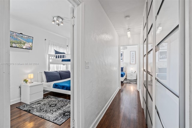 hallway with dark hardwood / wood-style flooring