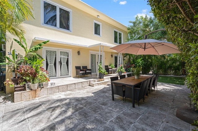 rear view of property featuring a patio area and french doors