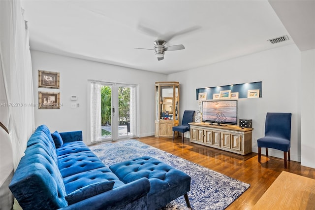 living room with ceiling fan, french doors, and dark hardwood / wood-style floors