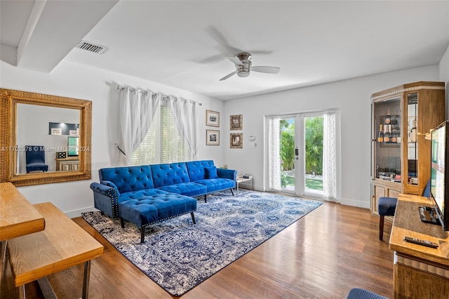 living room with hardwood / wood-style floors and ceiling fan