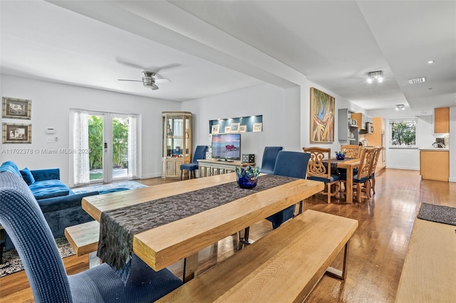 dining room with hardwood / wood-style floors, french doors, and ceiling fan