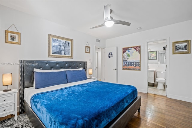 bedroom with ensuite bath, ceiling fan, and wood-type flooring