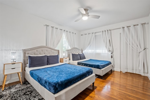 bedroom with ceiling fan and hardwood / wood-style flooring