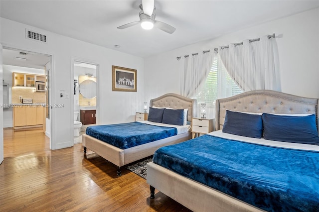 bedroom with wood-type flooring, connected bathroom, and ceiling fan