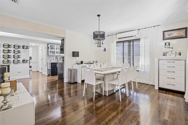 dining space with dark hardwood / wood-style floors, a wall unit AC, and a chandelier