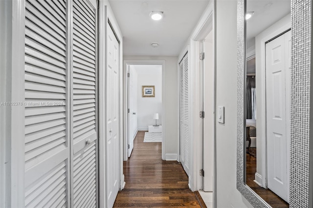 hallway with dark hardwood / wood-style floors