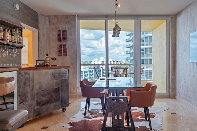 dining room featuring expansive windows and indoor bar