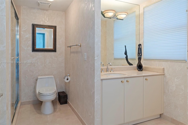 bathroom with vanity, toilet, and tile patterned flooring